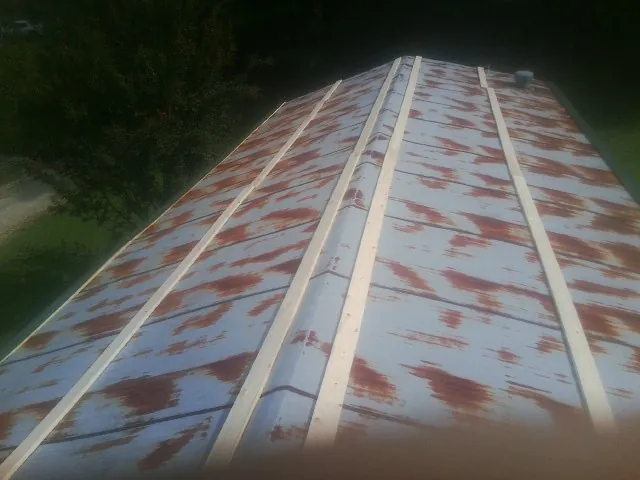 Rusted metal roof panels with new wood purlins before replacement — Storm Damage Roof Repair in Escondido by Roofing Brothers