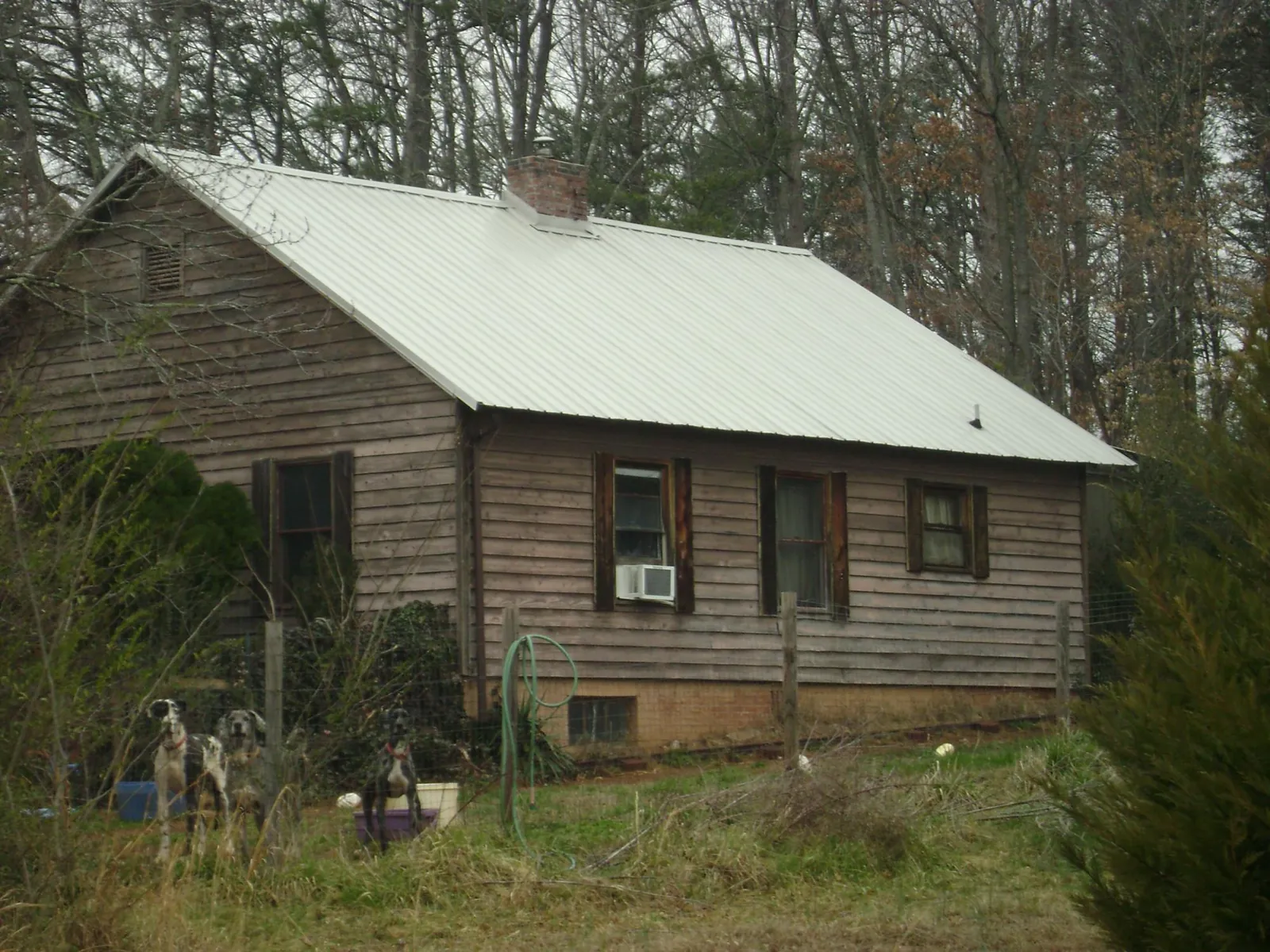 White metal roof on an old wood sided farmhouse, from a Metal Roof Installation job in Escondido